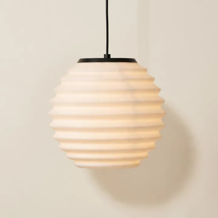 A round white pendant with horizontal ridges